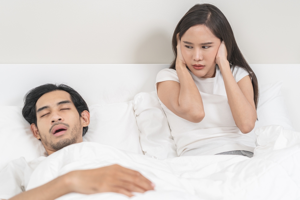 couple troubled by snoring and sleep apnea